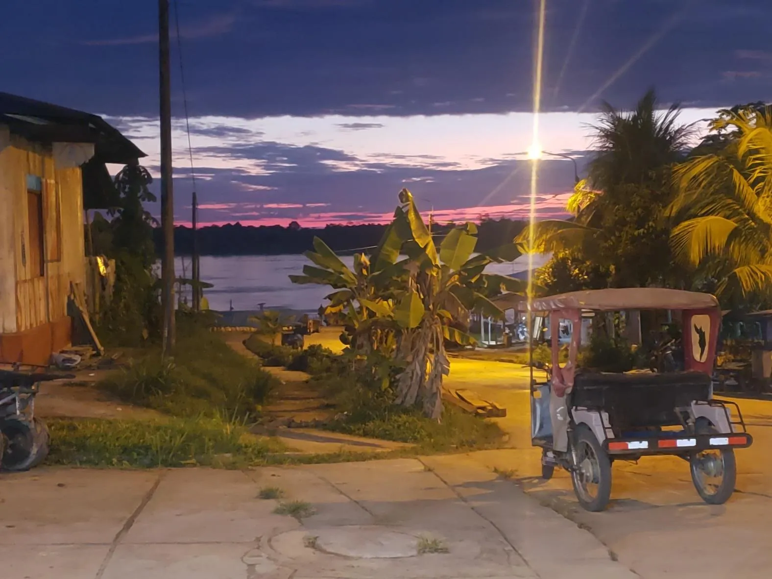A quiet street in Tamshiyacu at sunset, near the river — the last stretch of the journey to the center.